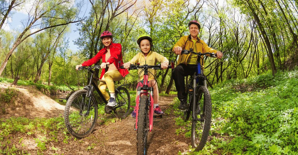 The Sweet Spot Where Small-Town Charm Meets Big Adventure - family mountain biking on a trail